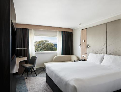 a hotel room with a large bed and a window at Hyatt Place London Heathrow Airport in Hillingdon