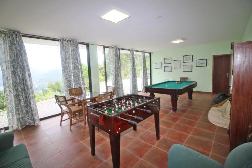 a living room with a pool table and agamuitous at Casa da Quintã Gerês by Gerês Casas in Vieira do Minho