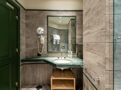 a bathroom with a sink and a mirror at Numa Milan Camperio in Milan