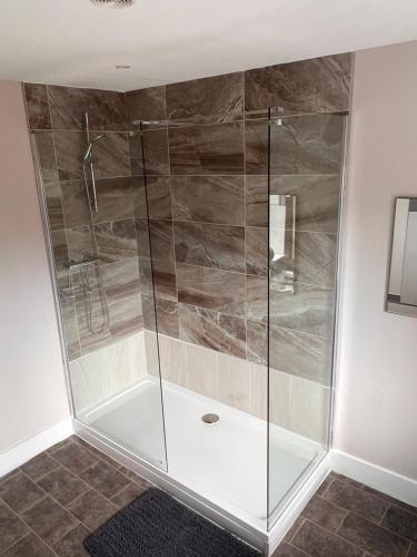 a shower with a glass door in a bathroom at Spire View at THE GALLEON RESTAURANT in Chesterfield