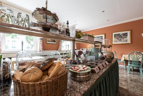 a kitchen with a counter with baskets of bread at Hotel Kurfürstenhof in Bonn