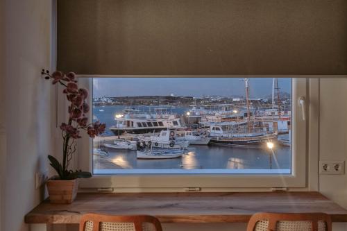 a window with a view of a marina at Nautica Suites - Modern Seaview Suite in Antiparos Town
