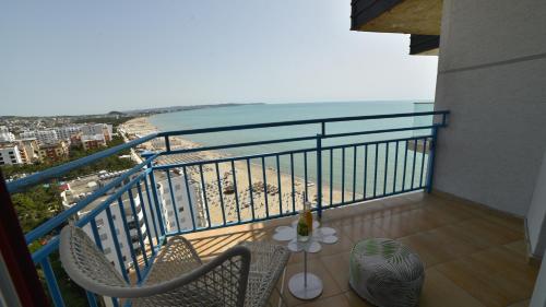 a balcony with a table and chairs and the beach at Beachfront Marilyn in Durrës