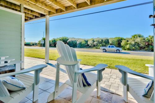 two chairs on a porch with a view of the road at Sunnyside on the Gulf #3 in Sunnyside