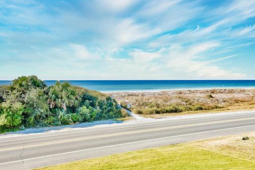 an empty road with the ocean in the background at Sunnyside on the Gulf #3 in Sunnyside