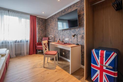 a hotel room with a bathroom with a sink and a desk at Hotel Kurfürstenhof in Bonn