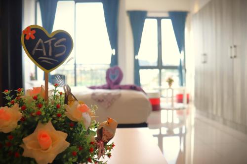 a heart sign and flowers on a table in a room at ATS Cameron Hotel & Apartments in Cameron Highlands