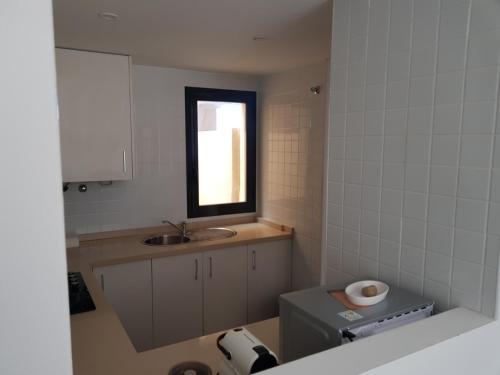 a small bathroom with a sink and a toilet at Corvera Golf Holiday Home in Murcia