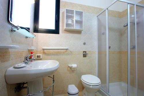 a bathroom with a toilet and a sink and a shower at La Dimora Siciliana in Trapani