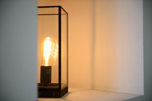 a lamp with a glass case on a table at Dream House Pompei in Pompei