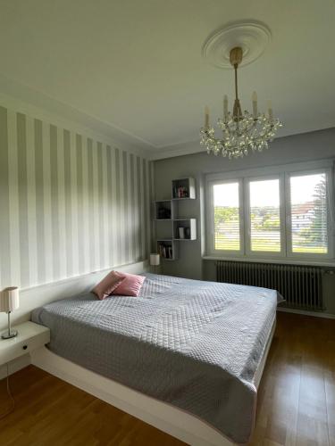 a bedroom with a bed and a chandelier at Ferienwohnung Eva in Mureck