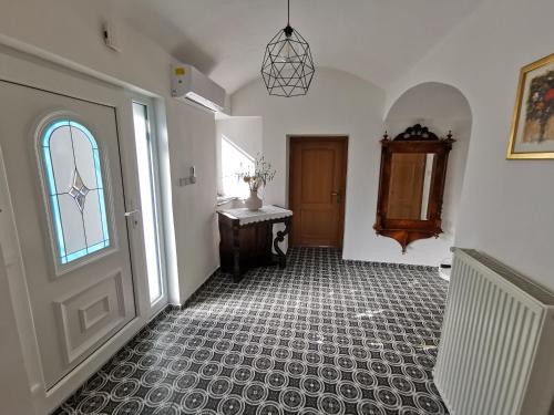 a hallway with a door and a tile floor at Charming village house with patio and garden in Slovenske Konjice