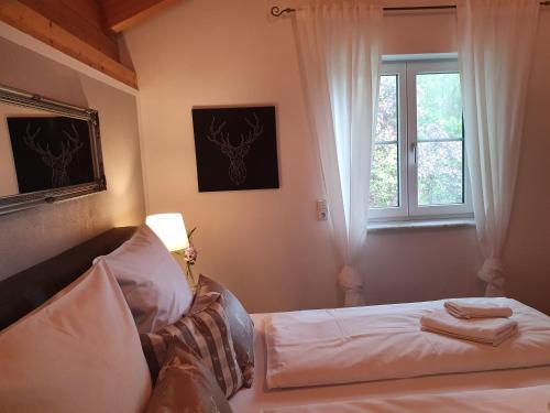 a bedroom with a bed and a window at Ferienwohnung Schmuckkastl in Tittmoning