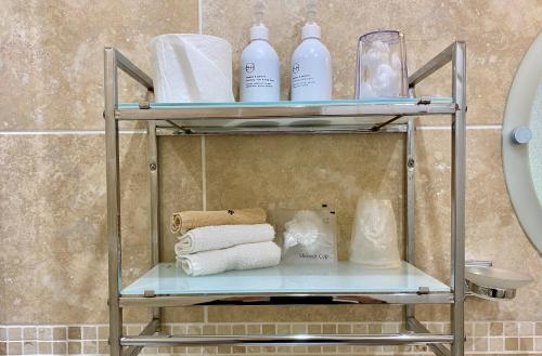 a shelf with towels and other items in a bathroom at Crow How Country Guest House in Ambleside
