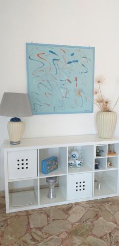 a white cabinet with a fish painting on it at Le Terrazze in Carini