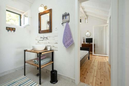 a bathroom with a sink and a bed in a room at Lavender Dreams Cottage Hvar in Stari Grad