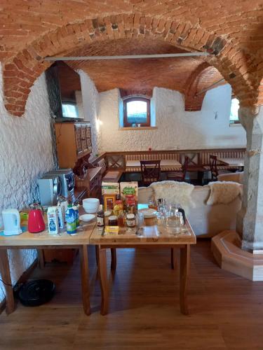 a living room with a wooden table in a house at B&B family room Tubej in Bohinj