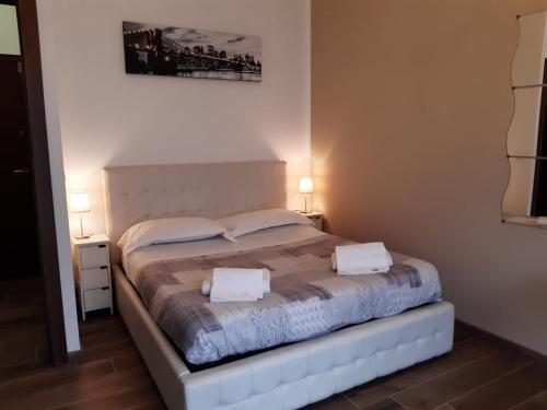 a bedroom with a bed with two towels on it at San Donato Apartment in Turin