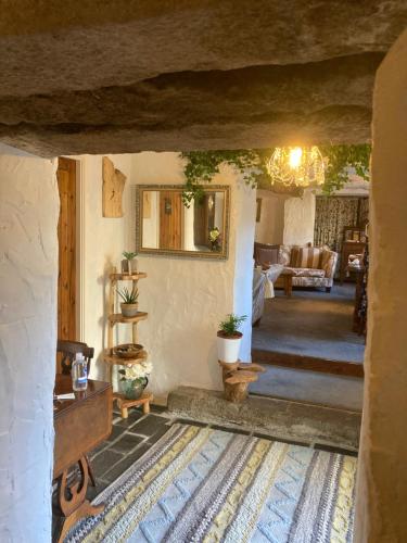 a living room with a couch and a table at Bissick Old Mill Suite in Truro