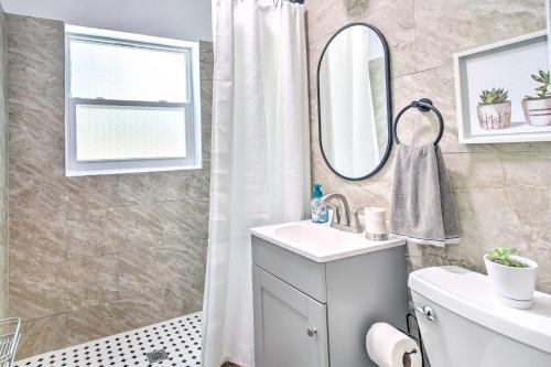 a bathroom with a sink and a mirror at Family-Friendly Clearwater Home with Game Room! in Clearwater
