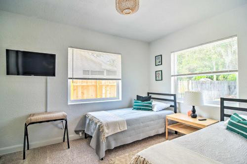 a bedroom with two beds and a flat screen tv at Family-Friendly Clearwater Home with Game Room! in Clearwater