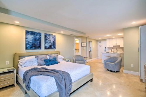 a bedroom with a bed and two chairs and a kitchen at Oceanfront Luxury Renovated Resort Getaway! in Fort Lauderdale