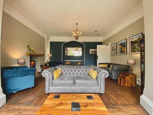 a living room with a couch and a table at Crow How Country Guest House in Ambleside