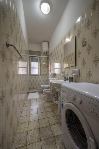 a bathroom with a washer and a washing machine in it at La Valle di Hermes in Piraino