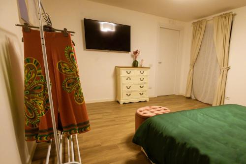 a bedroom with a bed and a television on the wall at Sweet House in Nocera Inferiore