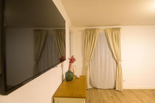 a room with a window with curtains and a table at Sweet House in Nocera Inferiore