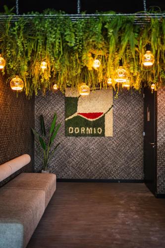 a lobby with a sign on a wall with lights at Dormio Wijnhotel Valkenburg in Valkenburg