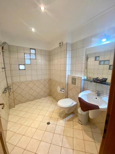 a bathroom with a toilet and a sink at Family Hotel The Golden fish in Sozopol