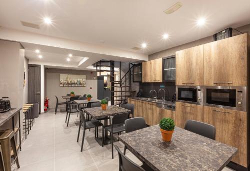 a kitchen and dining room with tables and chairs at Guesthouse No. 48 in Msida