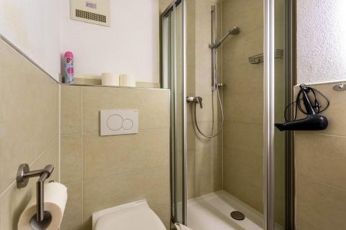 a bathroom with a shower stall and a toilet at Studio Bergblick in Inzell