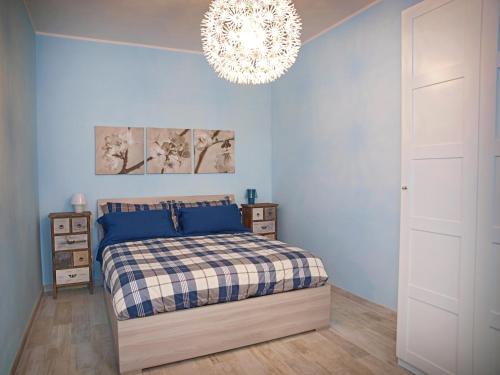 a bedroom with a bed and a chandelier at Appartamenti Pistrella in Orvieto