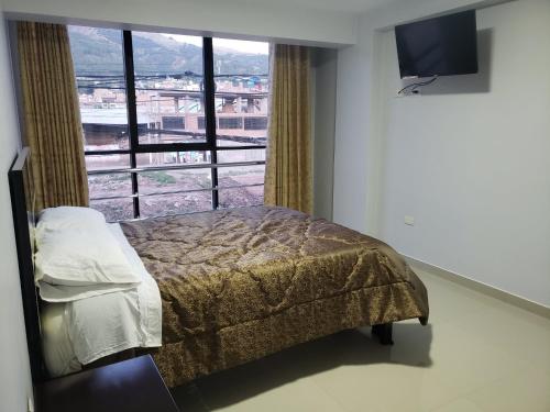 Ένα ή περισσότερα κρεβάτια σε δωμάτιο στο Hotel Apu Kempor
