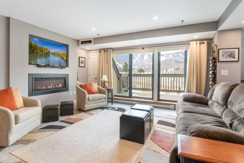a living room with two couches and a fireplace at Walk to Lifts and Village! Killington Mountain Condo in Killington