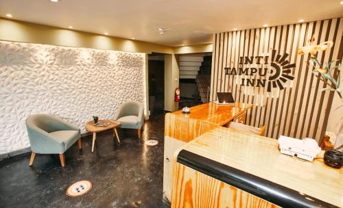 a lobby with two chairs and a reception desk at Inti Tampu Inn in Cusco