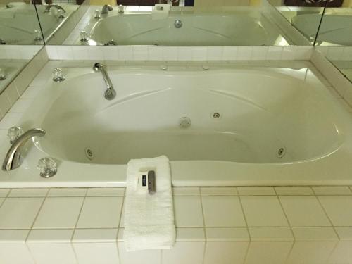 a bath tub in a bathroom with a towel on it at Deerfield Inn in Somerville