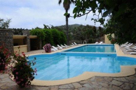 a large swimming pool with lounge chairs around it at Auberge des Cascades Imouzzer - Paradise Valley in Imouzzer des Ida Ou Tanane