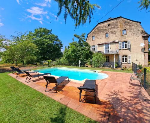a swimming pool in front of a large stone building at Schloss Hilbringen in Merzig