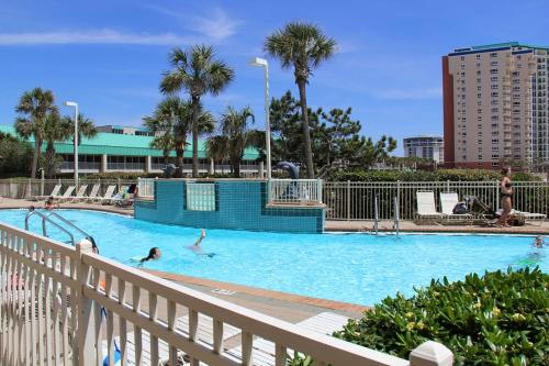 a large swimming pool with people in the water at Pelican Beach Terrace 805 in Destin
