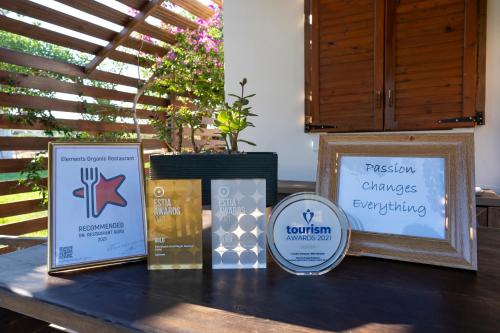 a table topped with signs on top of a table at Eco Beach And Magic Garden Hotel in Gennadi