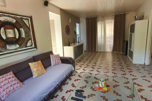 a living room with a couch and a table at Résidence Belle Anse Trois-ilets in Les Trois-Îlets