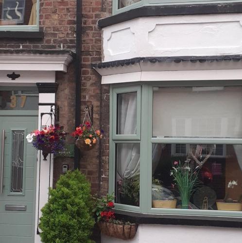 a window of a house with flowers in it at The Holly & Ivy in Bridlington
