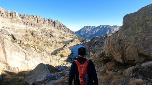 a man standing on a mountain looking at a canyon at Hotel Els Encantats in Espot