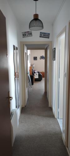 a hallway leading to a living room with a hallway at Loc'Eric in Pont-lʼAbbé