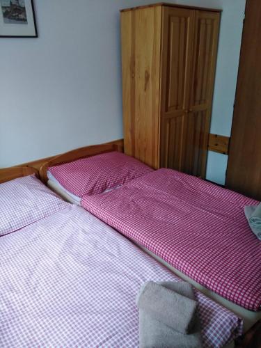 two beds sitting next to each other in a room at Penzion Iris Krkonoše in Horní Maršov