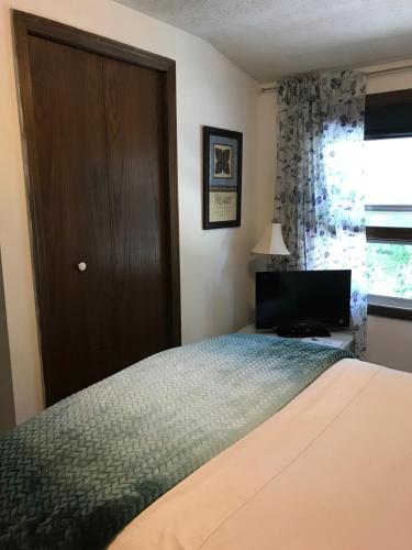 a bedroom with a bed and a door and a window at Hope Bed and Breakfast in Canton