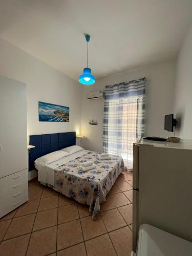 a bedroom with a bed in a room with a window at Artista studio in Cefalù